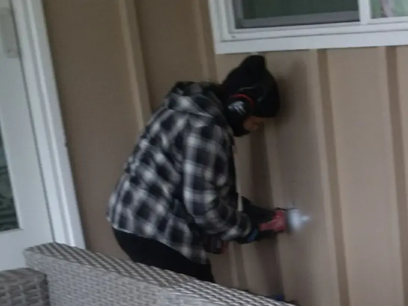 Professional electrician installing an exterior outlet in Andrews