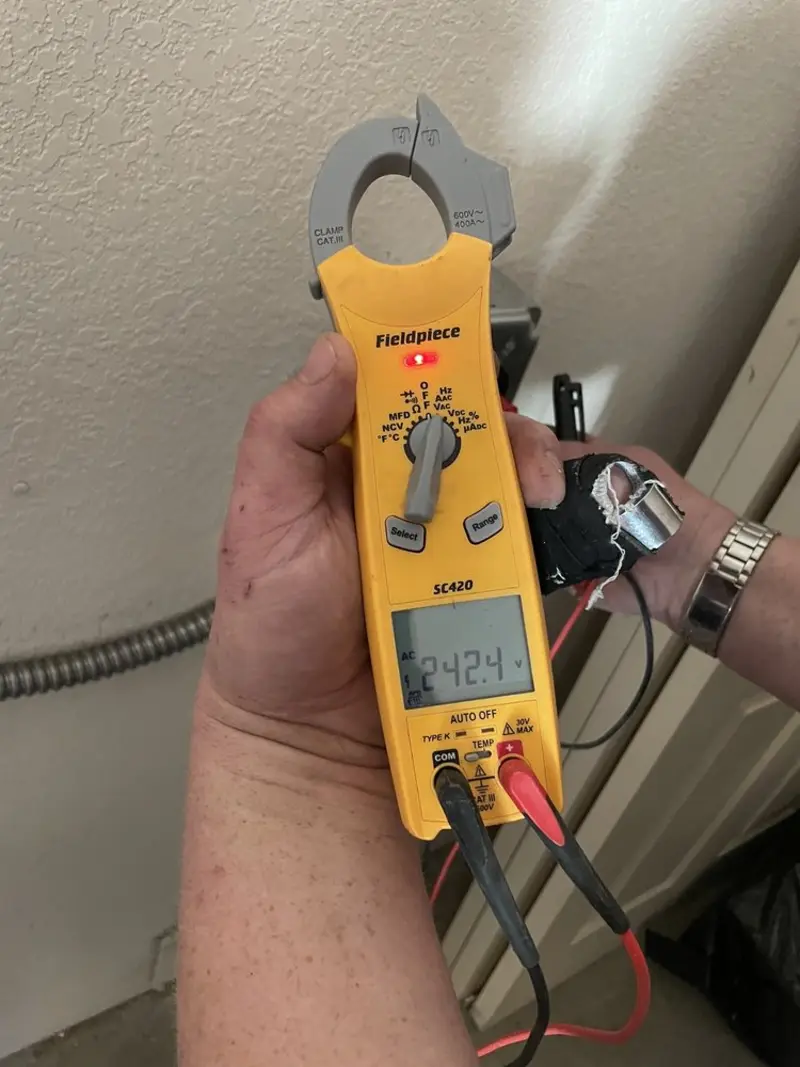Voltage testing with clamp meter during Outlet Installation in Andrews